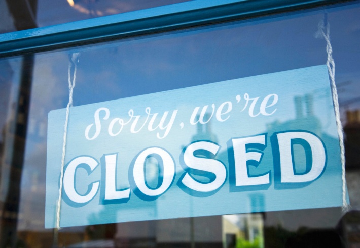 Close up of store closed sign saying sorry, were closed